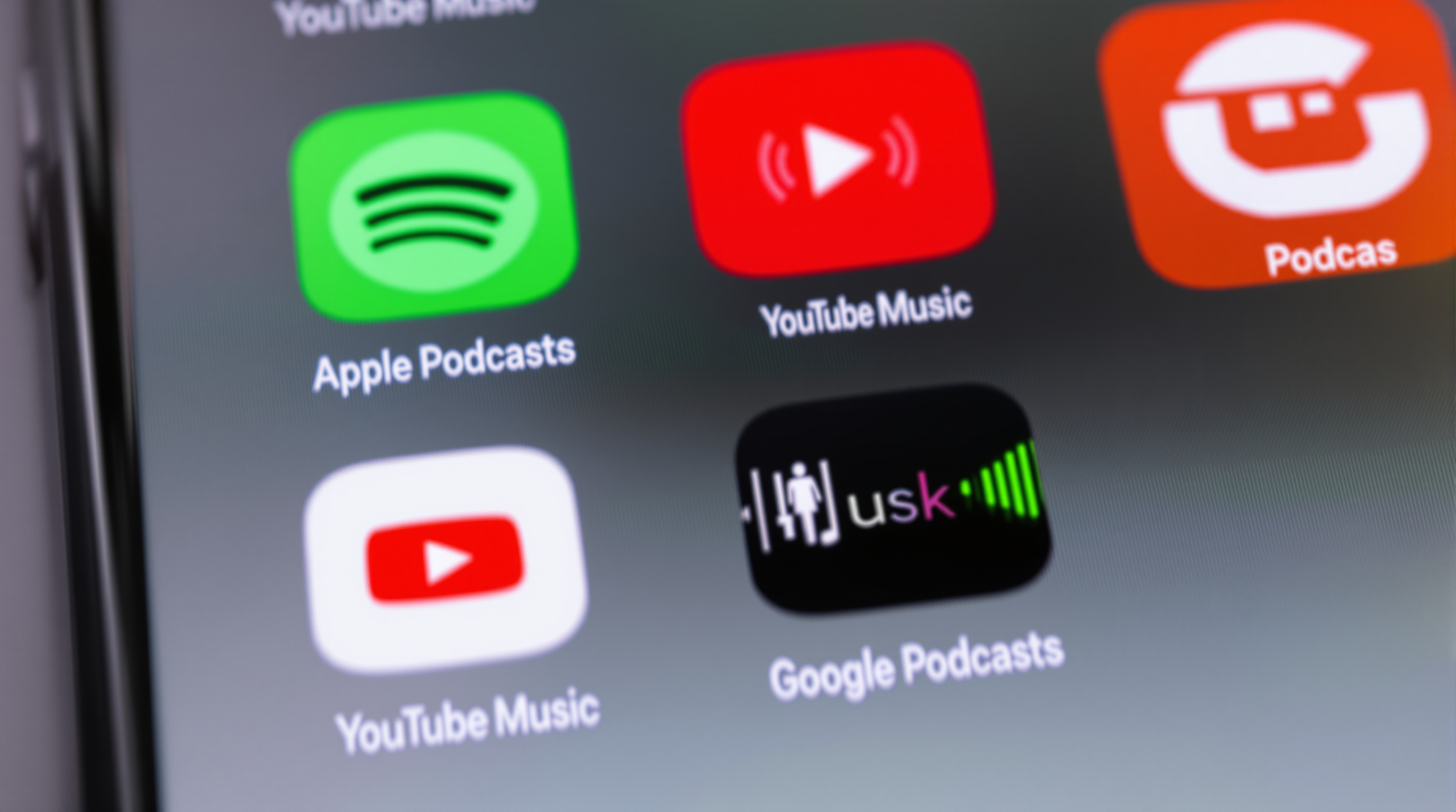 Podcast app icons on smartphone screen